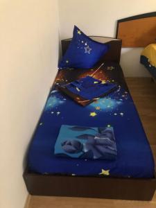 a bed with a blue comforter with stars on it at Casa Cleopatra 2 MAI in 2 Mai