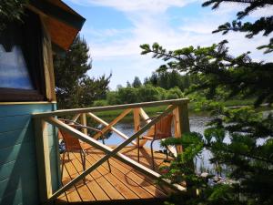 a wooden deck with a view of a lake at Kaptenimaja koos saunaga in Tartu