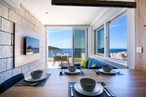 a dining room with a table and a view of the ocean at Villa Leoni in Dubrovnik