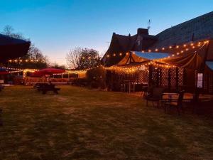 a group of tents lit up with lights at night at The Hand Hotel in Chirk