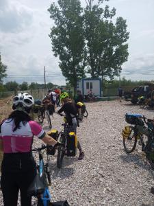 a group of people riding bikes on a gravel road at Camping Danubius Tulcea in Tulcea