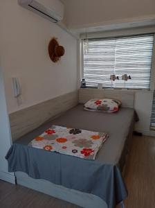 a small bedroom with a bed with a blanket on it at Studio San Stefano in Burgas