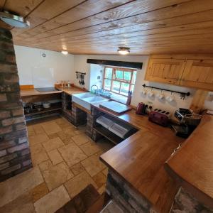 an overhead view of a kitchen with wooden walls and wooden floors at Loch Lomond shore Boat House in Balmaha