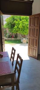 an open door to a patio with a table and chairs at Orange Garden Loft in Kala Nera