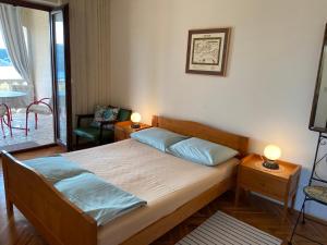 Postel nebo postele na pokoji v ubytování Apartments Stella-Dora