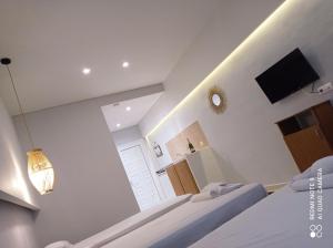 two beds in a room with a tv and a window at Cavo D' Oro Complex in Kavos