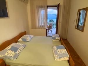 Postel nebo postele na pokoji v ubytování Apartments Stella-Dora
