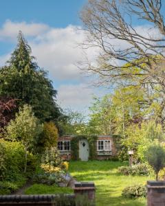 a house in the middle of a garden at Large Luxury Solihull 5 Bedroom House - The Residence - Close to NEC - Sleeps 9 in Solihull