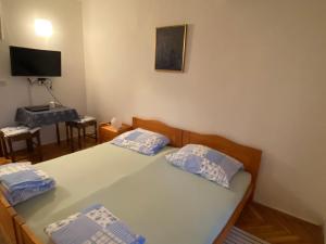 Postel nebo postele na pokoji v ubytování Apartments Stella-Dora
