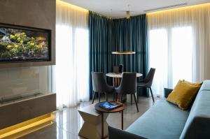 a living room with a blue couch and a table at L-Suites in Kavála