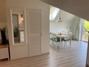 a dining room with a table and a mirror at Apartamenty u Kasi in Kudowa-Zdrój
