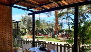 a patio with a table and a playground at Alegria Villas Complex in Vasilikos