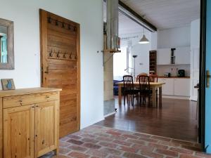a kitchen and dining room with a wooden door at Country home @ the Danube Bend in Nagymaros