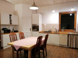 a kitchen with a table and chairs in a room at Country home @ the Danube Bend in Nagymaros