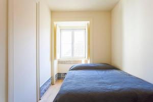 Ένα ή περισσότερα κρεβάτια σε δωμάτιο στο Flat do Chiado 03