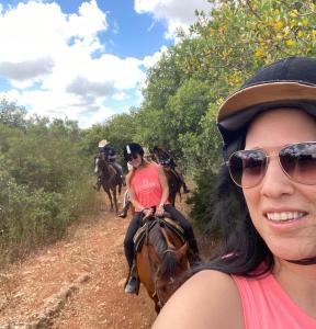 a group of people riding horses on a dirt road at The Riders' Experience - Glamping and Attractions Park- Full Board in Beit Oren