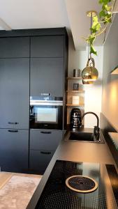 a kitchen with a sink and a stove at Lovely apr with sauna at the best area of Oulu in Oulu