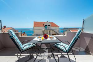 stół i krzesła na balkonie z widokiem na ocean w obiekcie Apartment Tonka w mieście Cavtat