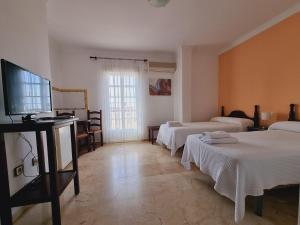A bed or beds in a room at Victoria Hotel