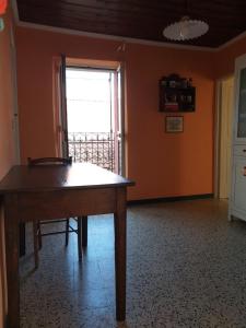 a dining room with a table and a window at la punta dei crociati in Parodi Ligure