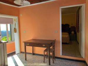 a room with a wooden table and a mirror at la punta dei crociati in Parodi Ligure