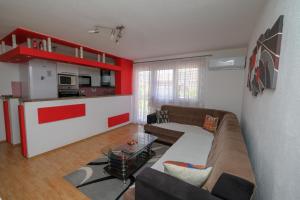 a living room with a couch and a kitchen at Vila melek 4 bedrooms in Sarajevo