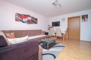 a living room with a couch and a table at Vila melek 4 bedrooms in Sarajevo