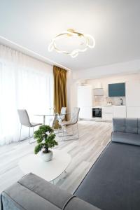 a living room with a couch and a table at Bel Air Apartments Mamaia Nord in Mamaia