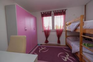 a bedroom with two bunk beds and a purple floor at Vila melek 4 bedrooms in Sarajevo +17 photos