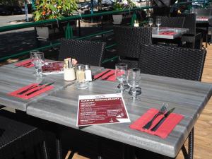 a table with red napkins and utensils on it at HOTEL LE FOIRAIL in Figeac