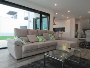 a living room with a couch and a glass table at Casa da Colina - Villa in the Countryside in Sobral do Parelhão