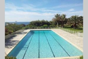 a swimming pool with the ocean in the background at Vu Mer by K6&You in Cassis