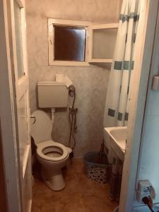 a small bathroom with a toilet and a sink at Бунгало- Bungalow in Kavarna