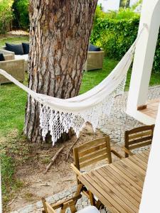 a hammock hanging from a tree in a yard at GOLF & BEACH VILLA in Vale do Lobo