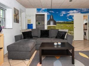 a living room with a couch and a table at Holiday home Skærbæk II in Skærbæk