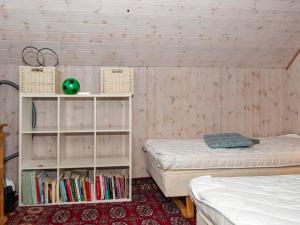 a room with two beds and a book shelf at Holiday home Skærbæk II in Skærbæk