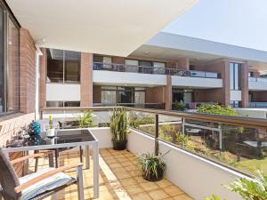 an apartment patio with a balcony with plants at The Commodore, 23,9-11 Donald Street - Delightful unit with gorgeous water views, air con and wi-fi in Nelson Bay