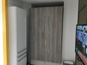 a large wooden cabinet in a room with a tv at Gwada dream in Saint-François +34 photos