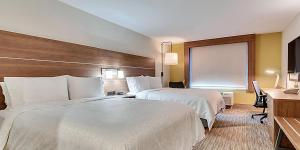 a hotel room with two beds and a desk at Holiday Inn Express Hotel & Suites Lake Elsinore, an IHG Hotel in Lake Elsinore