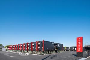 a row of shipping containers in a parking lot at HOTEL R9 The Yard Koga in Koga