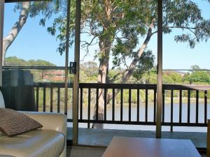 a living room with a view of a tree at Coolabah Court in Merimbula