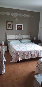 a bedroom with a large bed in a room at La Finestra Sul Cortile in Pomezia