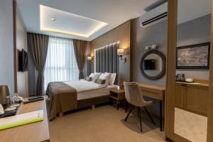 Tempat tidur dalam kamar di City Park Inn