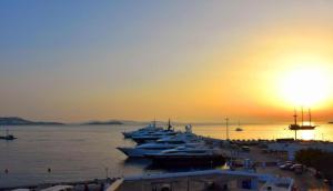 a group of boats docked in a harbor at sunset at Faro Sunset Suites in Mikonos