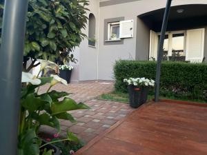 a house with a brick walkway in front of a house at Apartman VICINIM family friendly in Višnjan