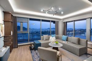a living room with a couch and a table at Citadines Yunlong Lake Xuzhou in Xuzhou