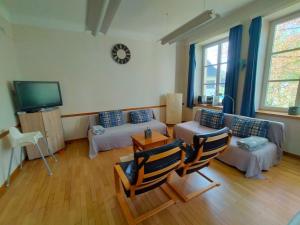 a living room with a couch and a tv at Gite rural a Bivels in Bivels