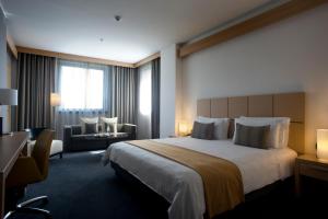 A bed or beds in a room at Domina Milano Fiera