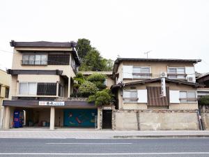 a building on the side of a street at Kikusui Ryokan in Tamano