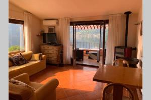 - un salon avec un canapé et une télévision dans l'établissement Cosy Penthouse with stunning view on Lugano Lake, à Cima
